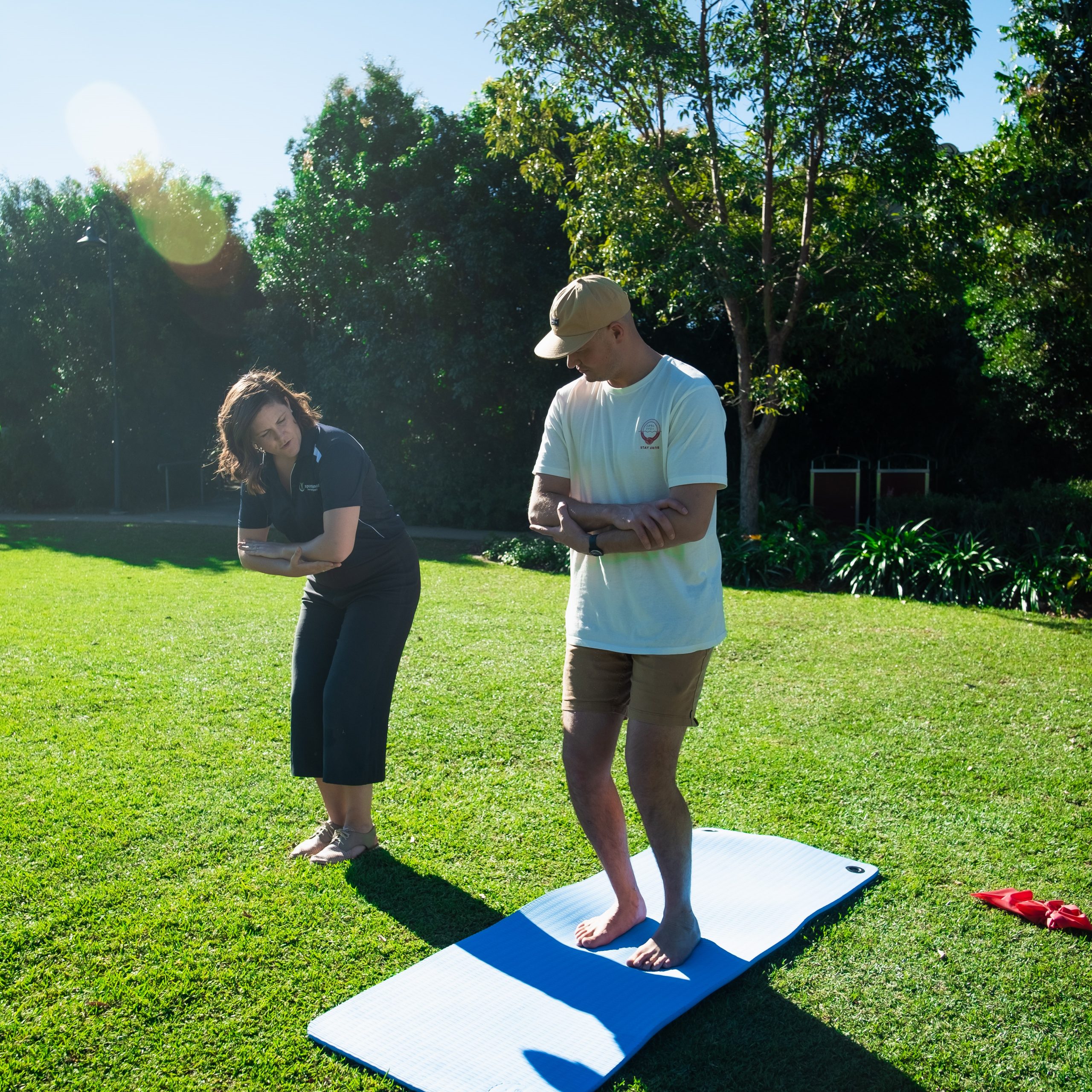 Physiotherapist and patient doing exercises in a park