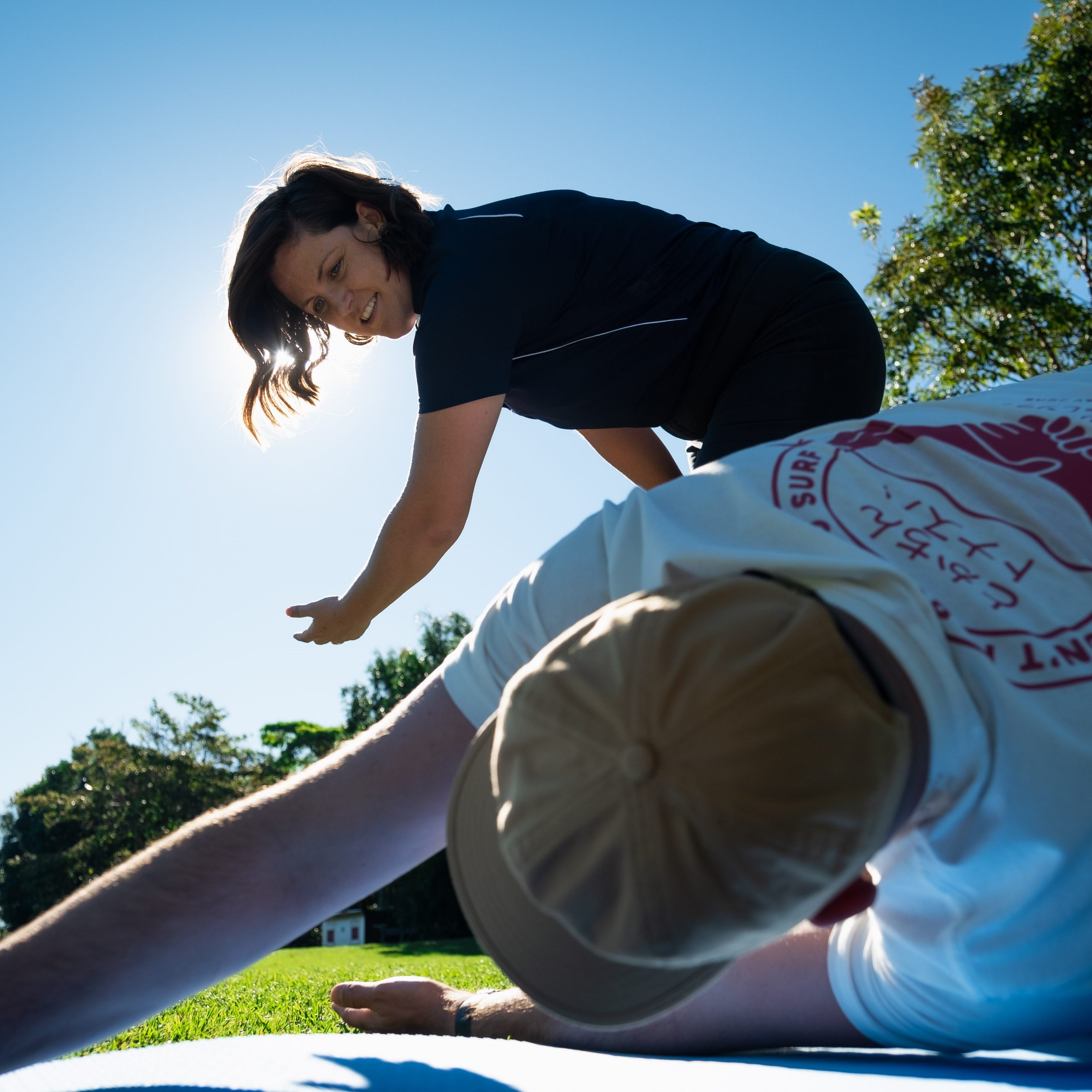 Physiotherapist and patient doing exercises in a park